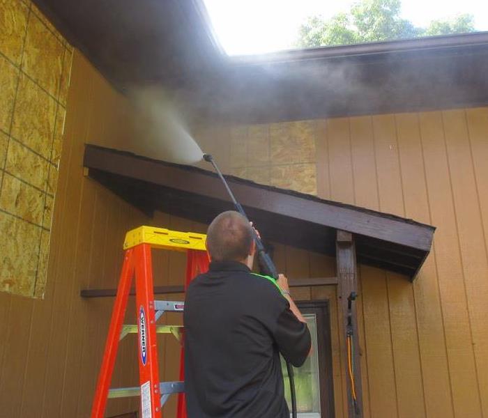 Pressure washing siding and soffit after a fire 